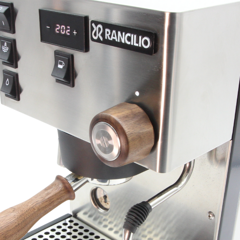 close up of stainless steel rancilio pro x with custom walnut accessory set