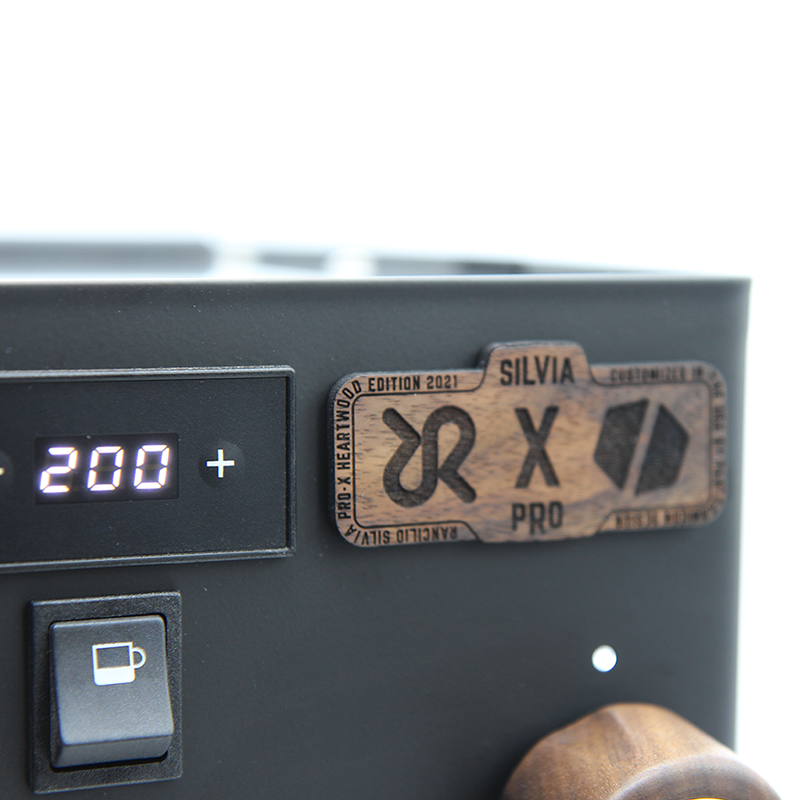 close up of laser cut silvia pro x and pantechnicon logo in walnut