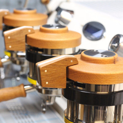 custom group cap in oak with matching brew paddle installed on a La Marzocco GS3 