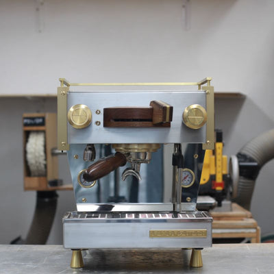 front view of custom linea mini in stainless steel with walnut and brass custom set