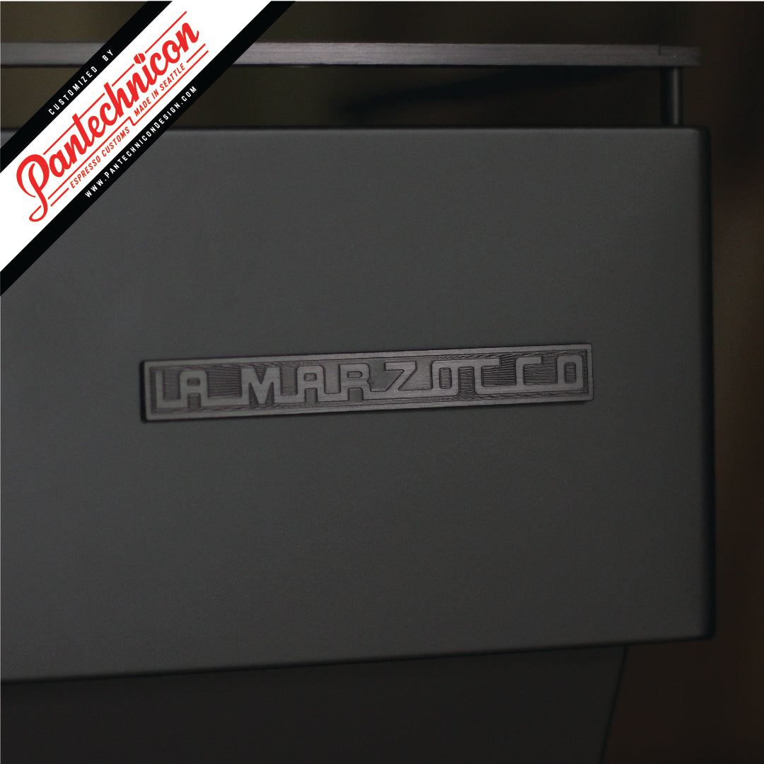 detail of anodized black la marzocco logo badge