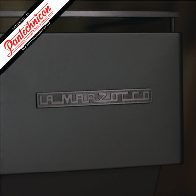detail of anodized black la marzocco logo badge