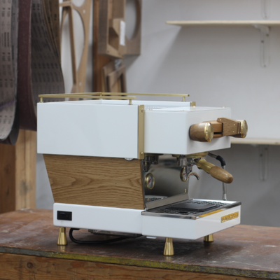 3/4 view of custom linea mini in white and walnut side panels with walnut and brass