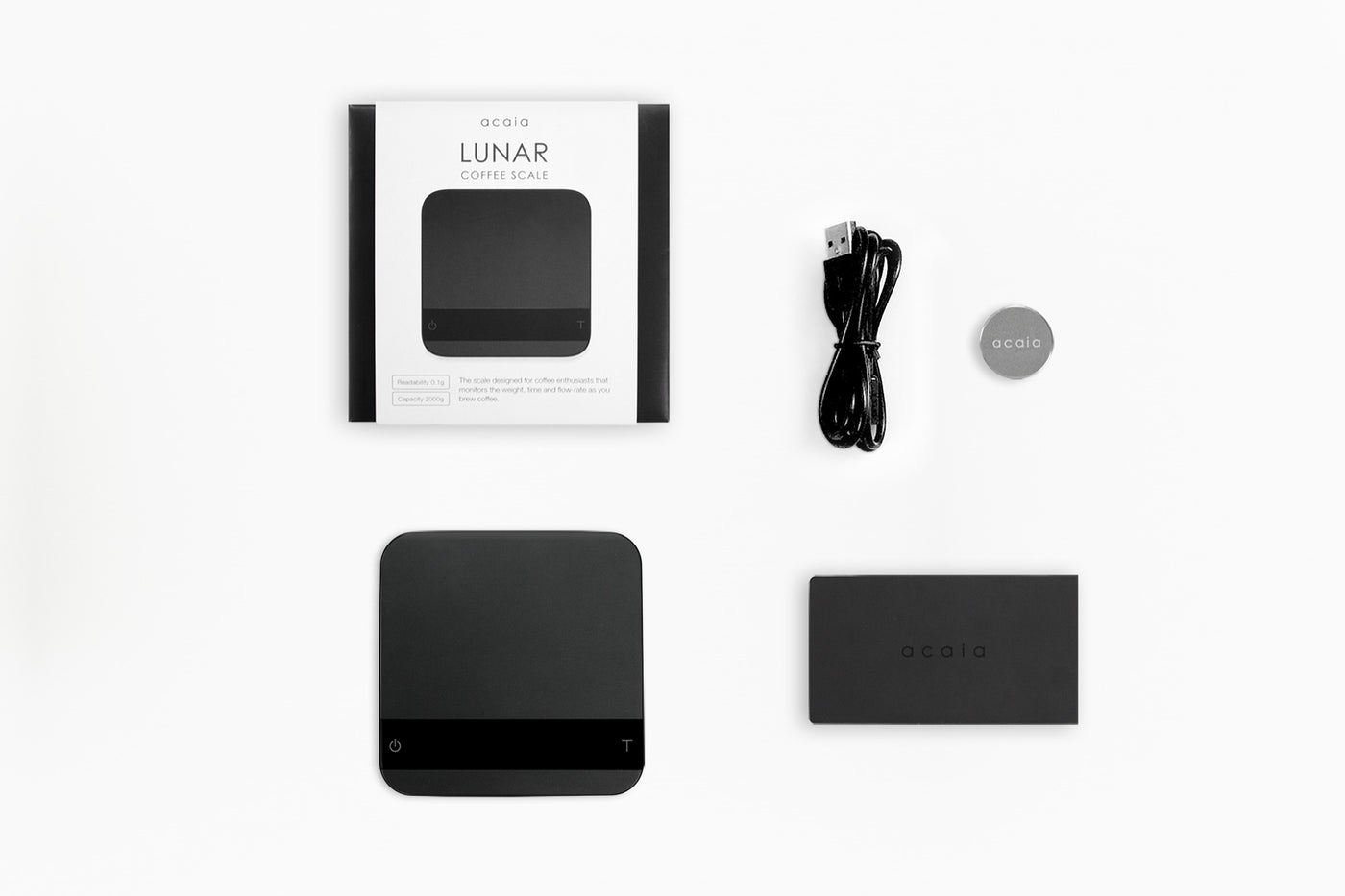 packaging of acaia lunar scale with cord, mat, and 100 gram weight